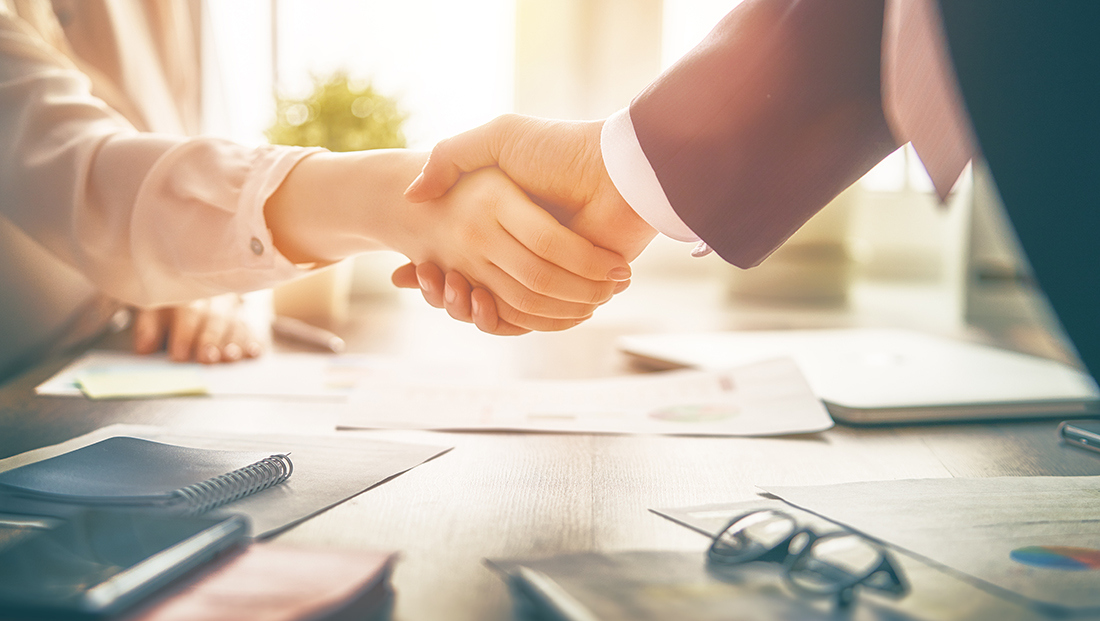 Engage employers: a man and a woman shaking hands in office