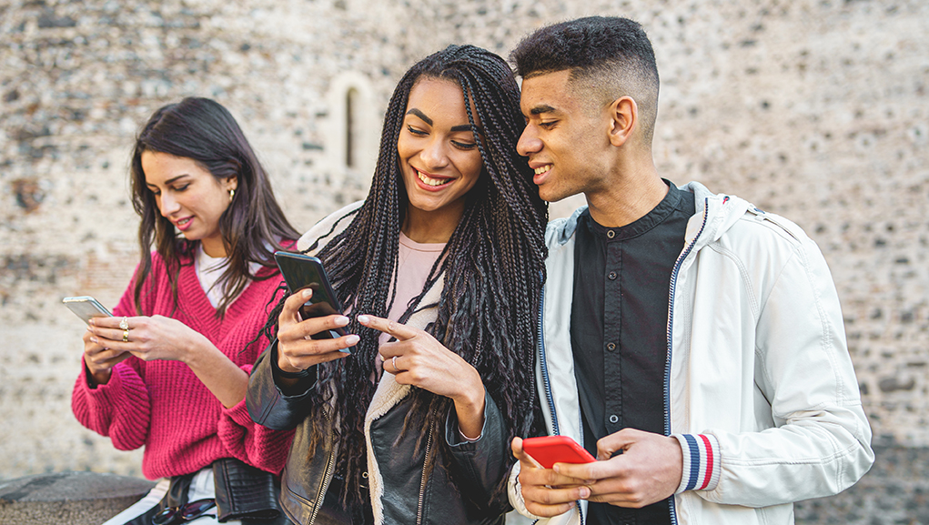 What students want from employers: a group of diverse students using smart phones