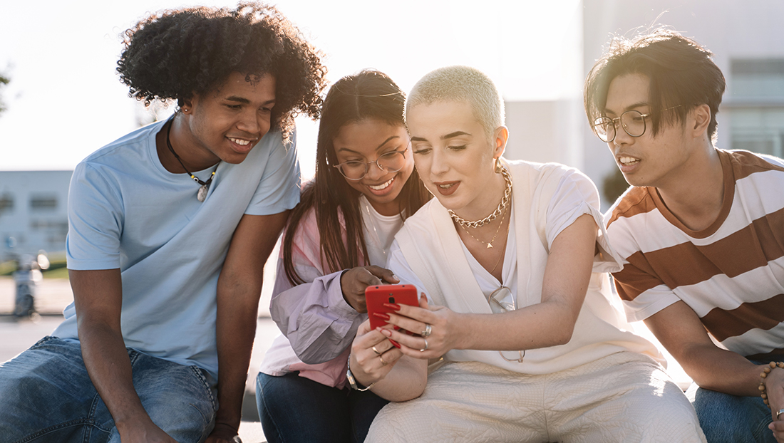 How to attract Gen Z: a group of friends sitting together using mobile phones