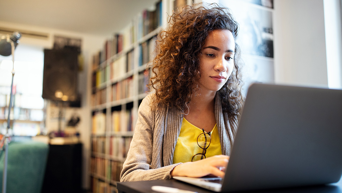 Alternatives to university: a female student working in the library