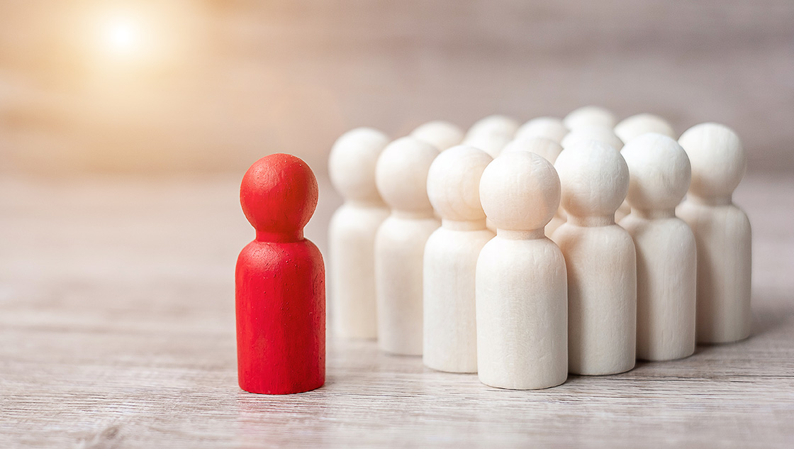 student employability: red wooden figurine amongst a group of white figurines