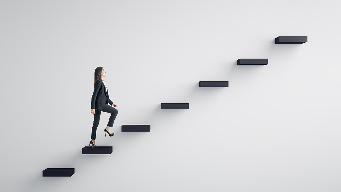 career stories: a woman going up the stairs