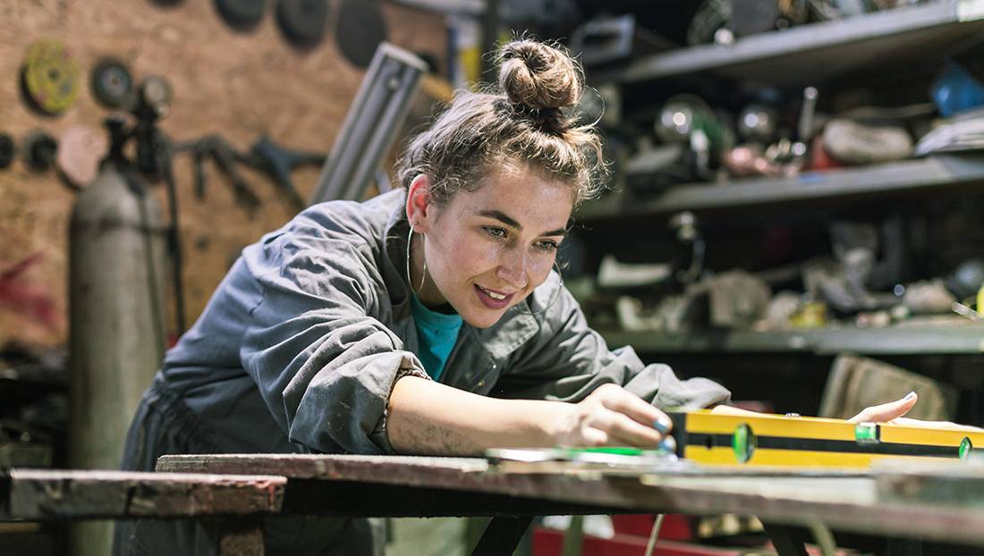 apprenticeship stigma: young woman working a workshop