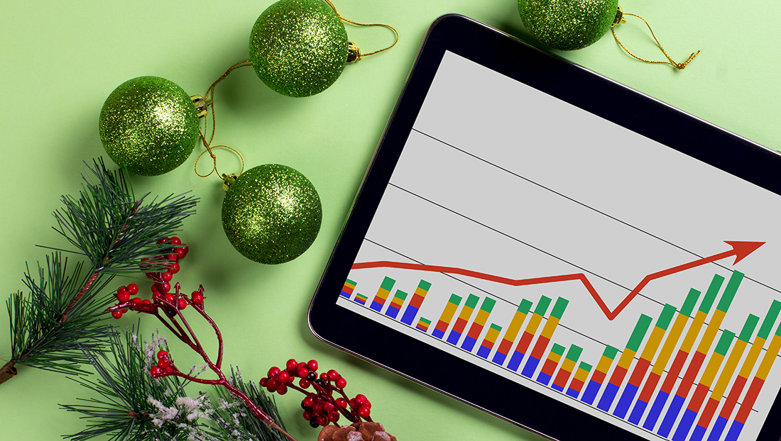 12 stats of Christmas: Christmas decorations and a tablet with a graph on the desktop