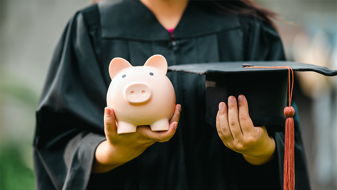 what does a recession mean for graduates: graduate holding a piggy bank