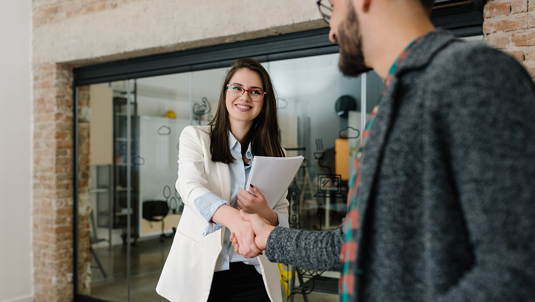 induction and onboarding: a manager greeting a new employee